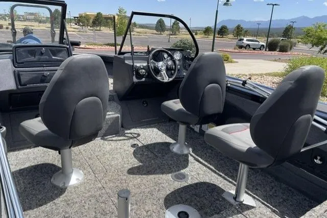 Slide: The Image of Interior of 2025 Tracker Targa V-18 WT boat with three seats and steering console. - 2