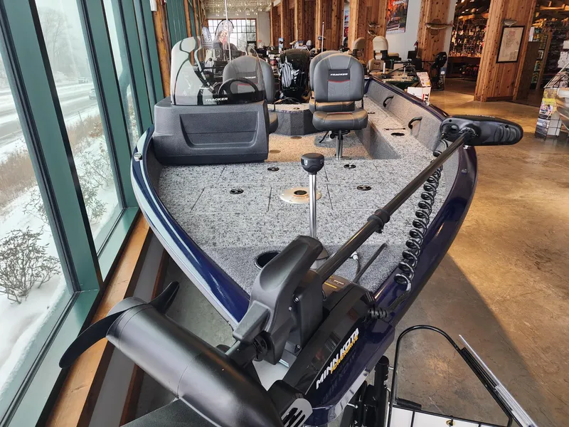 Slide: The Image of 2025 Tracker Pro Guide V-16 SC fishing boat displayed indoors. - 2