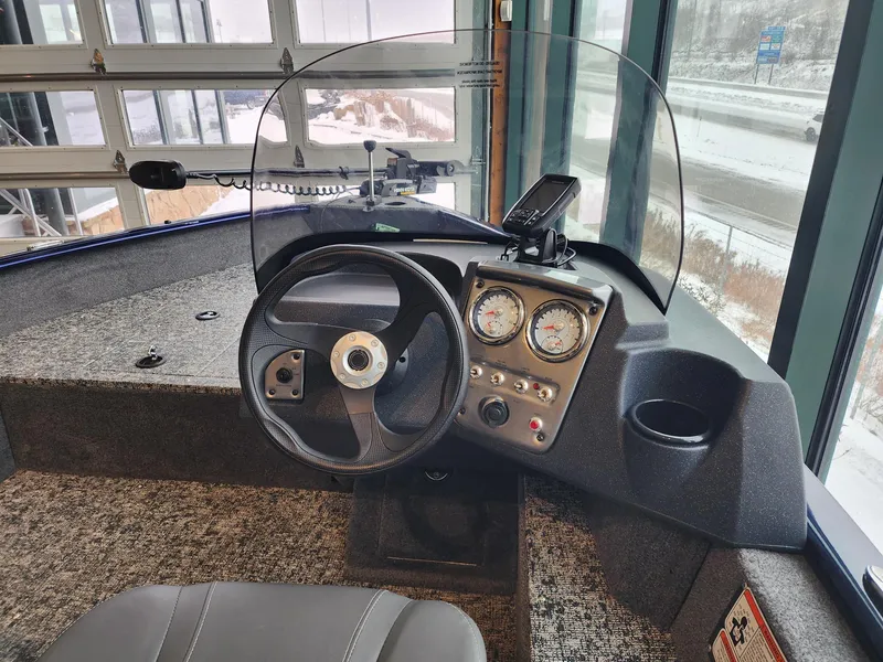 Slide: The Image of 2025 Tracker Pro Guide V-16 SC boat dashboard with steering wheel and gauges. - 5