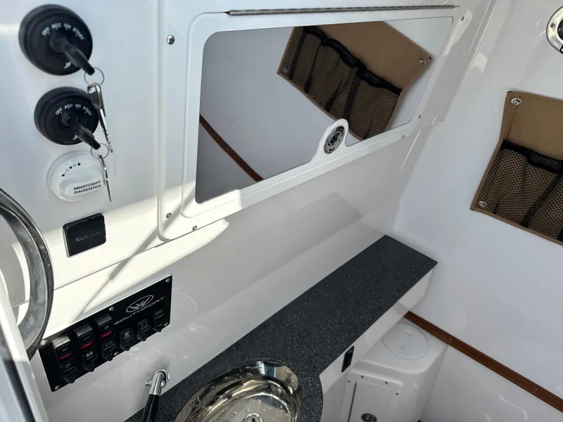 Slide: The Image of Interior view of 2025 Southport 33 DC boat with control panel and storage. - 13