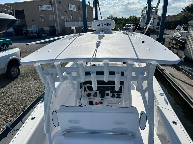 Slide: The Image of 2025 Southport 33 DC boat with Garmin navigation, docked at a marina. - 18