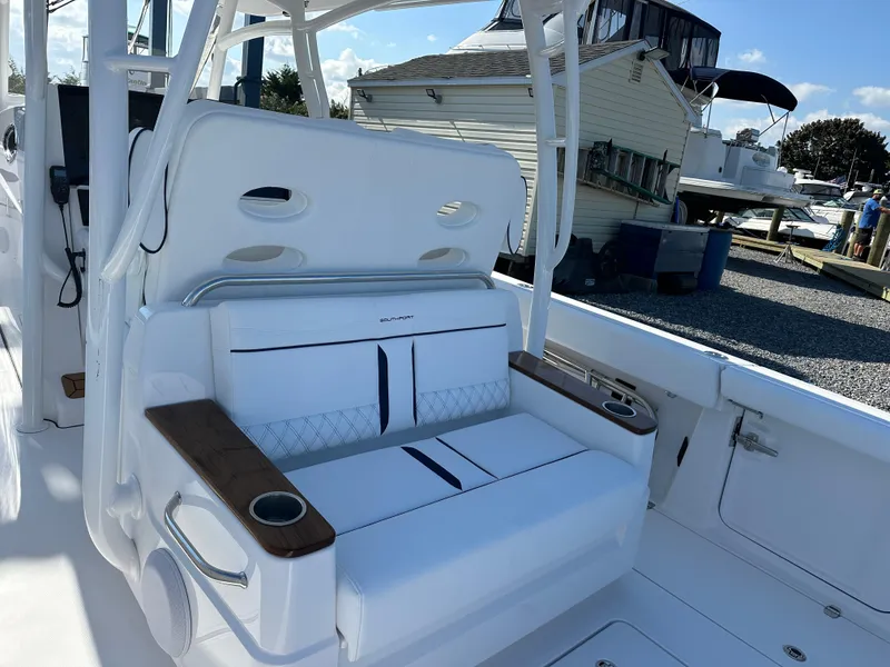 Slide: The Image of 2025 Southport 33 DC boat interior with white seating and cup holders. - 5