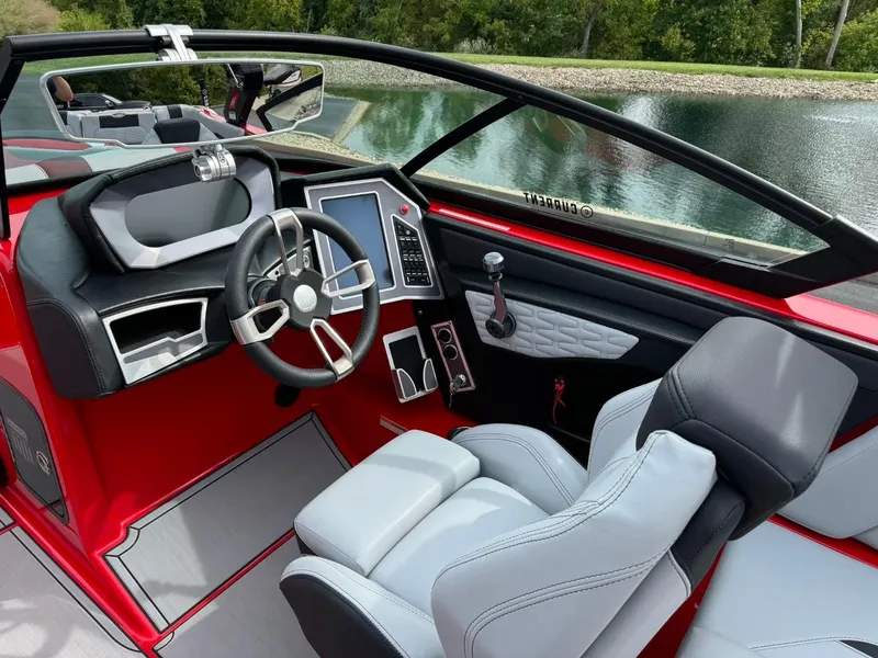 Slide: The Image of 2022 MasterCraft X24 boat interior with modern dashboard and sleek steering wheel design. - 10