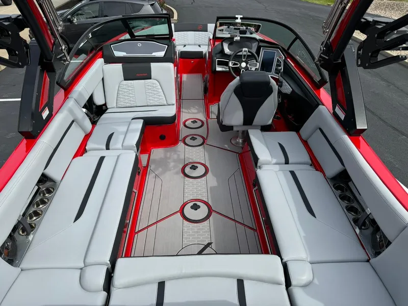 Slide: The Image of 2022 MasterCraft X24 boat interior with sleek seating and modern dashboard design. - 13