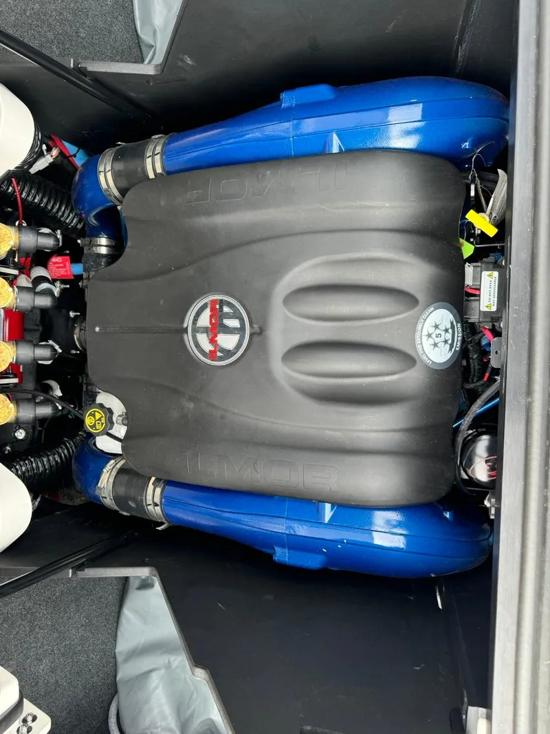 Slide: The Image of 2022 MasterCraft X24 engine compartment with blue and black components. - 14