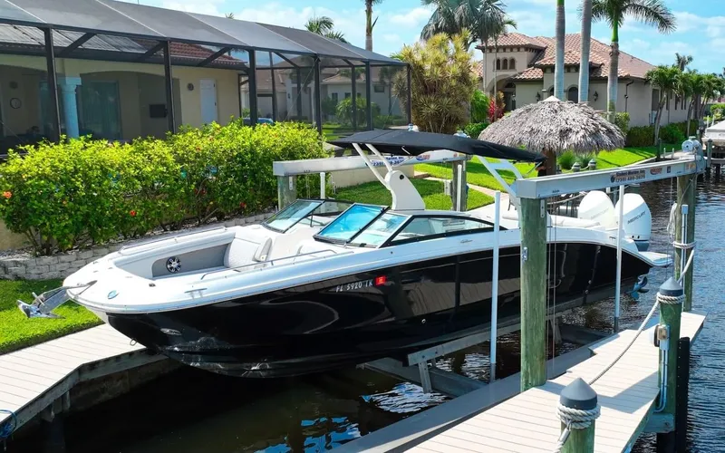 The Image of 2020 Sea Ray SDX 290 Outboard boat docked in a sunny waterfront setting. - 0