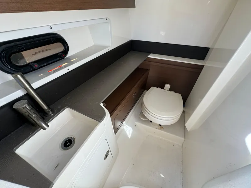 Slide: The Image of 2020 Sea Ray SDX 290 Outboard boat interior bathroom with sink and toilet. - 30