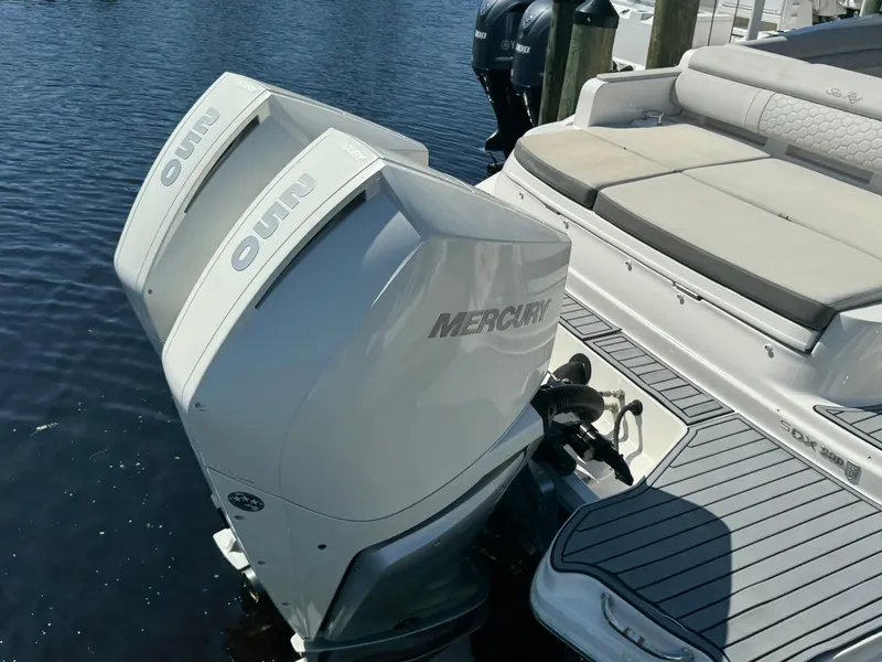 Slide: The Image of 2020 Sea Ray SDX 290 Outboard with twin Mercury engines, docked on calm water. - 6
