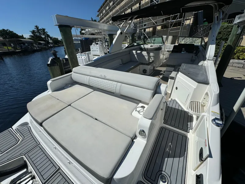 Slide: The Image of 2020 Sea Ray SDX 290 Outboard boat with spacious seating and sleek design at a marina. - 7