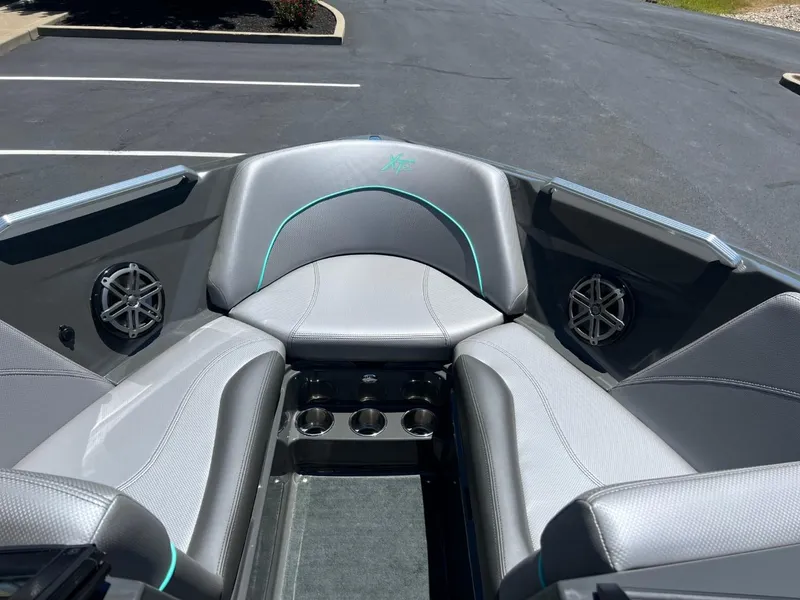 Slide: The Image of 2017 MasterCraft XT21 boat interior with gray seating and cup holders. - 10