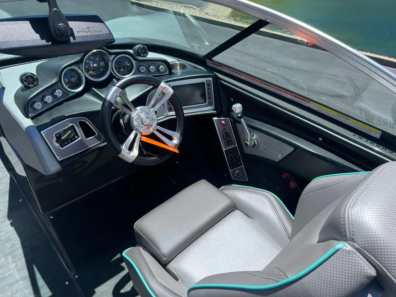 Slide: The Image of 2017 MasterCraft XT21 boat interior with modern dashboard and steering wheel. - 12