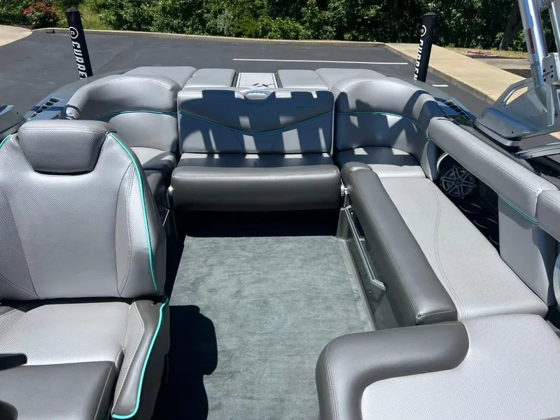 Slide: The Image of 2017 MasterCraft XT21 boat interior with gray seating and carpet. - 14