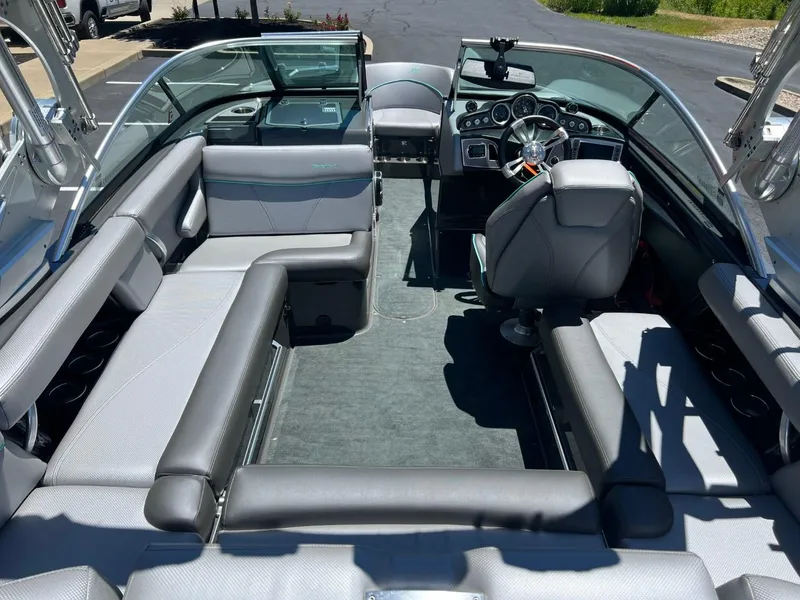 Slide: The Image of 2017 MasterCraft XT21 boat interior with gray seating and modern dashboard. - 15