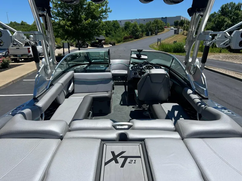 Slide: The Image of 2017 MasterCraft XT21 boat interior with sleek seating and modern dashboard. - 17