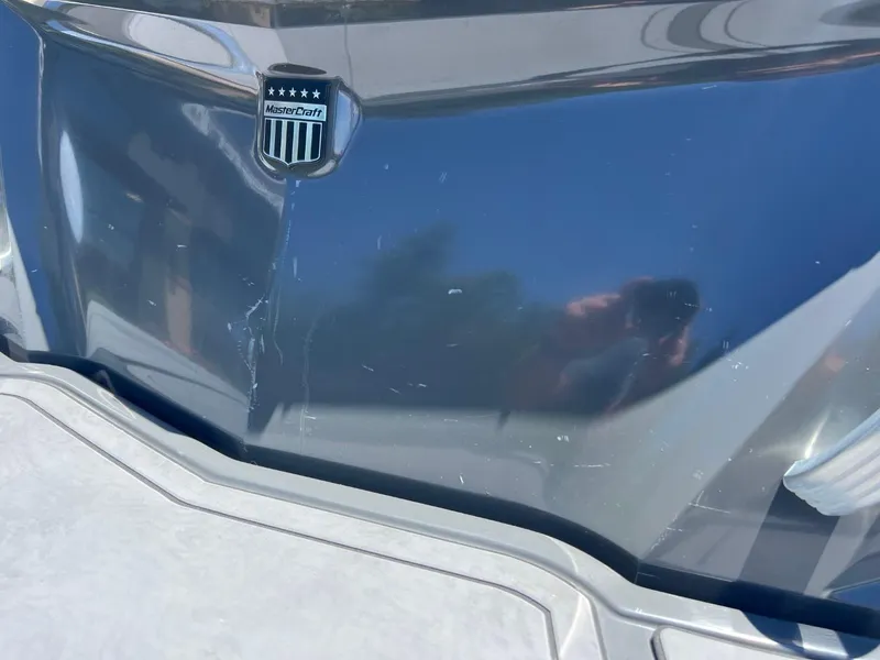 Slide: The Image of 2017 MasterCraft XT21 boat with visible scratches on the hull. - 6