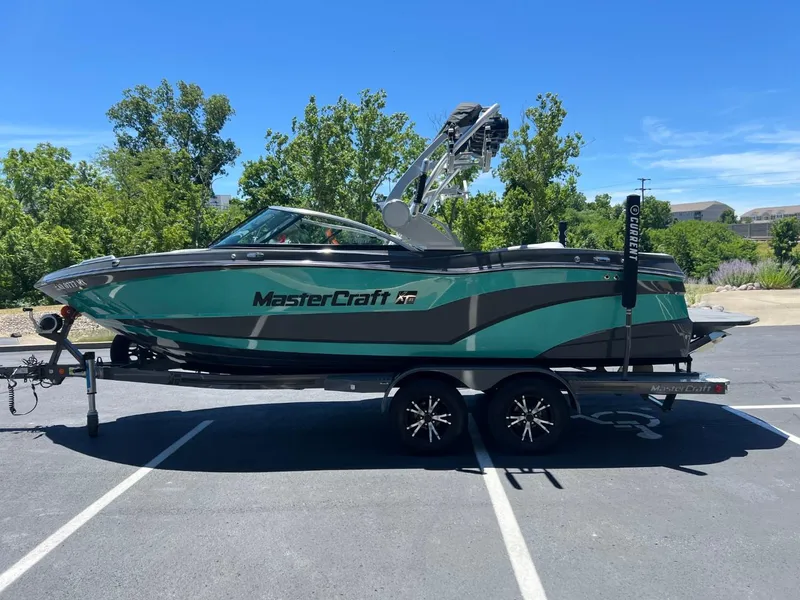 Slide: The Image of 2017 MasterCraft XT21 boat on trailer in sunny parking lot. - 8