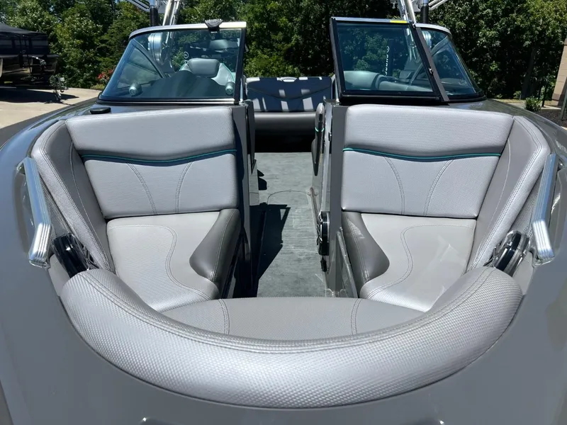 Slide: The Image of 2017 MasterCraft XT21 boat interior with gray seating and open bow design. - 9