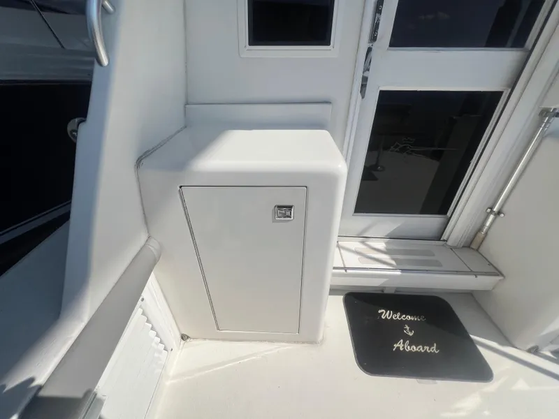 Slide: The Image of 1996 Egg Harbor Convertible yacht interior with welcome mat and storage compartment. - 13