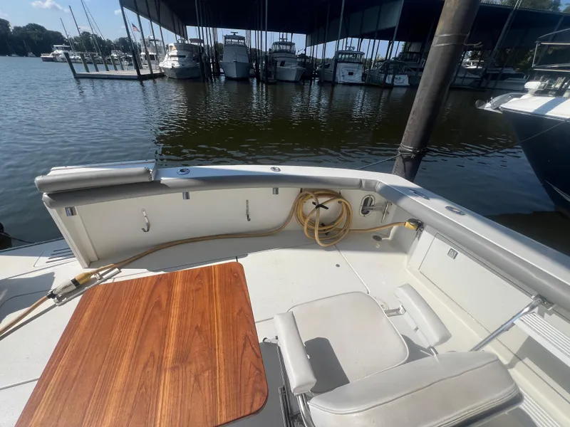 Slide: The Image of Egg Harbor 1996 Convertible boat interior with wooden table, docked at marina. - 15