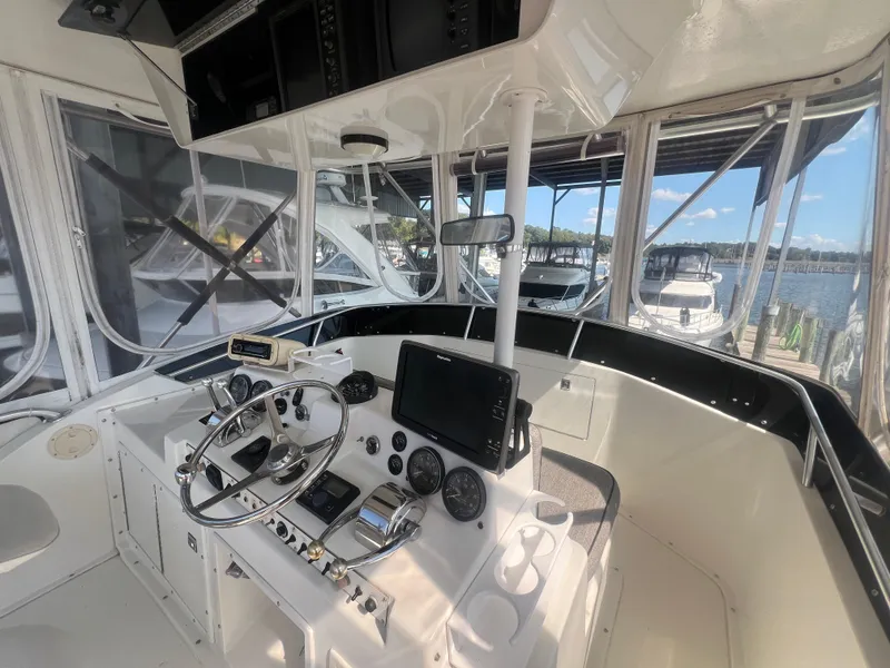 Slide: The Image of 1996 Egg Harbor Convertible boat helm with steering wheel and navigation equipment. - 20