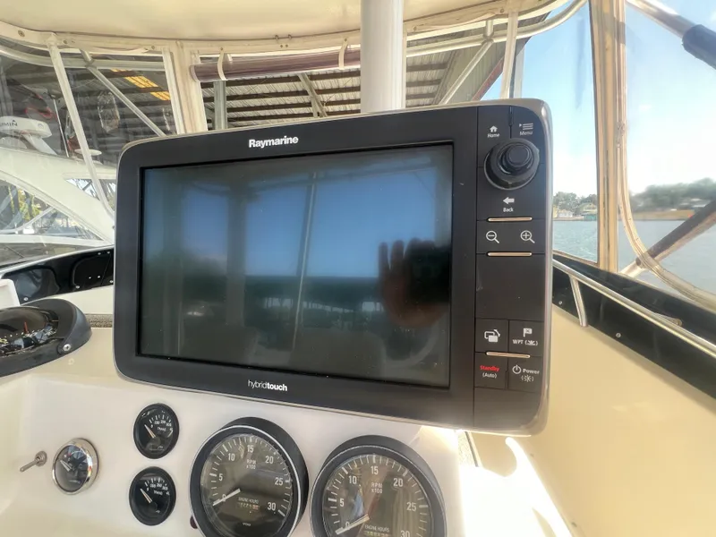 Slide: The Image of Raymarine display and gauges on 1996 Egg Harbor Convertible boat dashboard. - 21