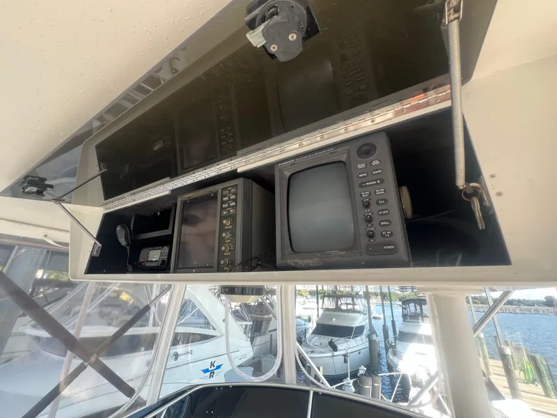 Slide: The Image of 1996 Egg Harbor Convertible boat electronics panel with vintage navigation equipment. - 22