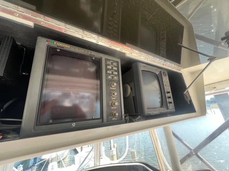 Slide: The Image of 1996 Egg Harbor Convertible boat dashboard with navigation equipment. - 24