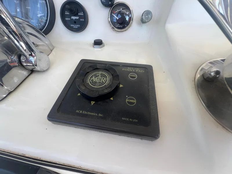 Slide: The Image of Control panel of a 1996 Egg Harbor Convertible boat with ACR Electronics. - 26