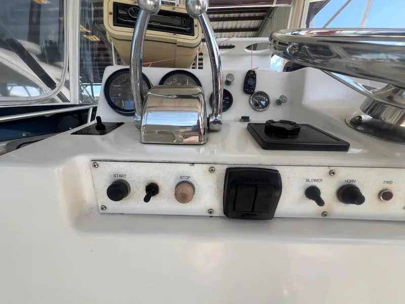 Slide: The Image of 1996 Egg Harbor Convertible boat control panel with throttle and switches. - 31