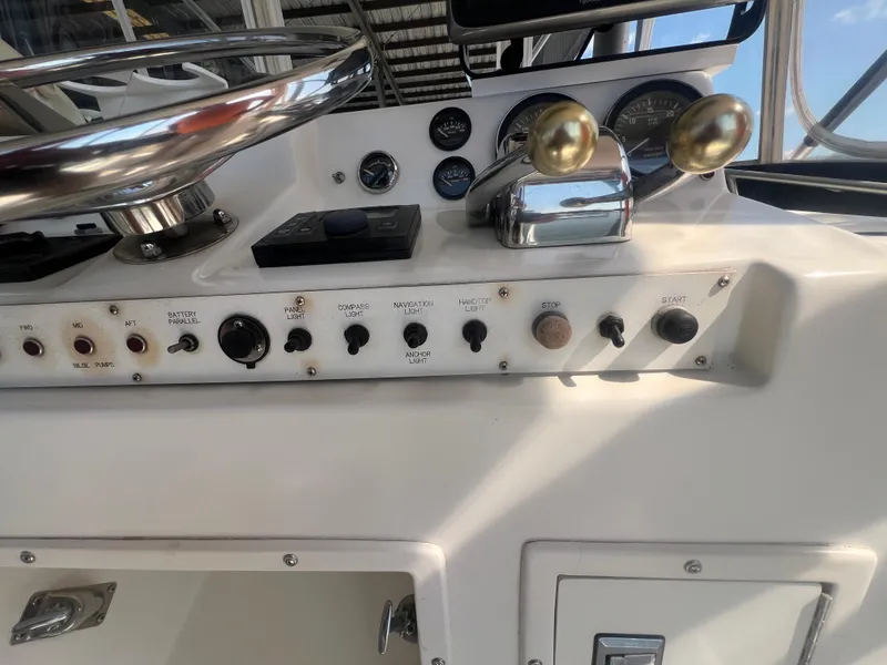 Slide: The Image of 1996 Egg Harbor Convertible boat dashboard with controls and gauges. - 32