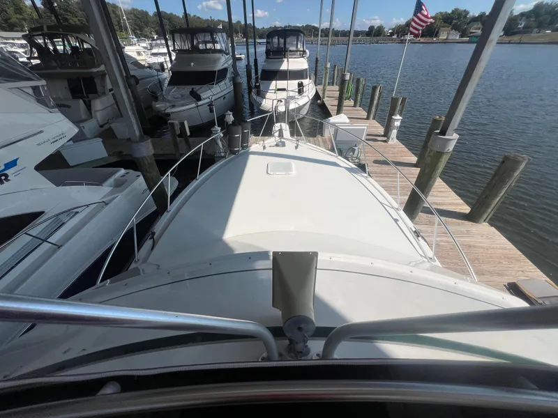 Slide: The Image of 1996 Egg Harbor Convertible yacht docked at marina with American flag. - 35