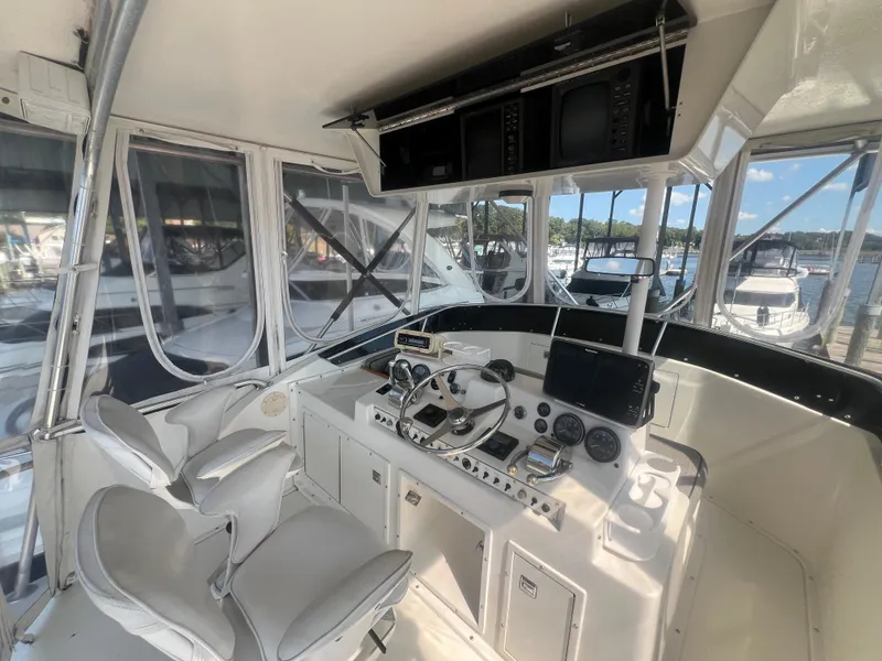 Slide: The Image of Interior of 1996 Egg Harbor Convertible yacht with modern navigation equipment and seating. - 37