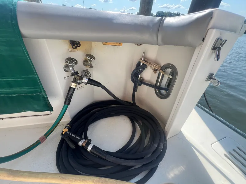 Slide: The Image of 1996 Egg Harbor Convertible boat deck with hoses and fittings. - 38