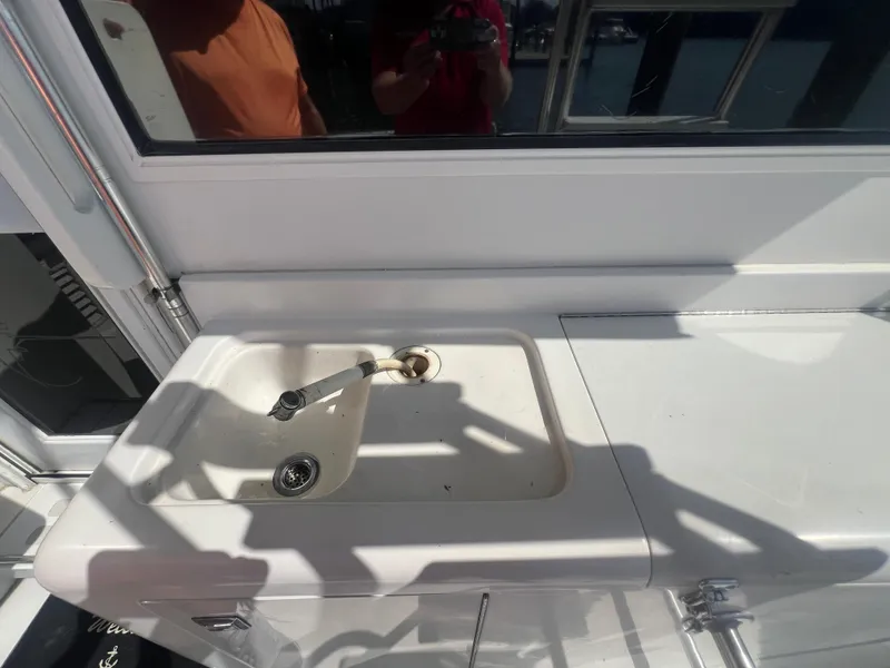 Slide: The Image of 1996 Egg Harbor Convertible boat sink and counter area. - 39