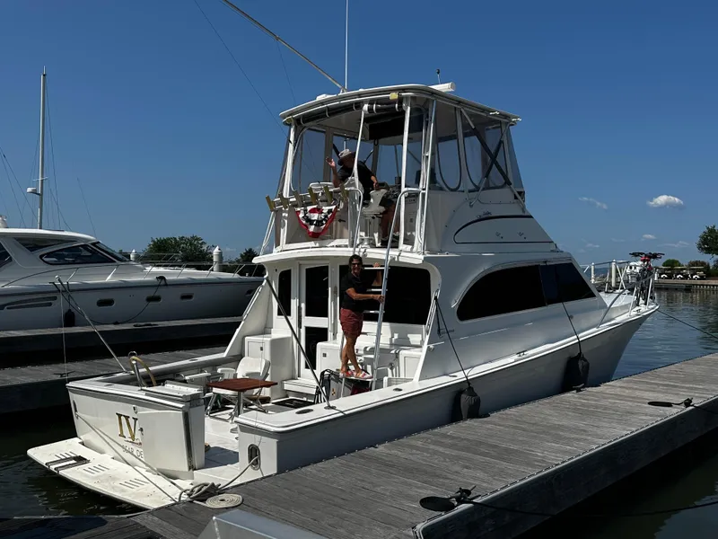 Slide: The Image of 1996 Egg Harbor Convertible yacht docked at marina under clear blue sky. - 4