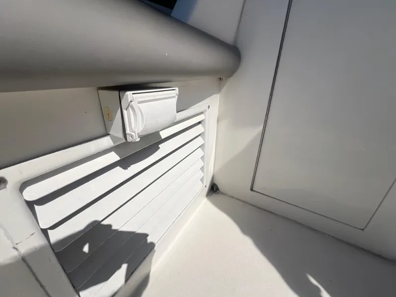 Slide: The Image of 1996 Egg Harbor Convertible boat interior detail with vent and electrical outlet. - 40