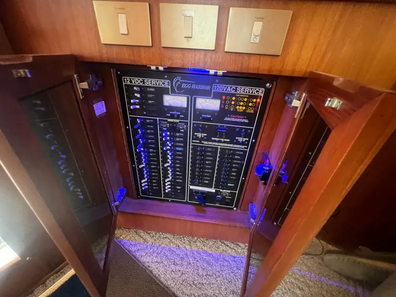 Slide: The Image of Electrical panel of a 1996 Egg Harbor Convertible boat, showcasing 12VDC and 120VAC services. - 43