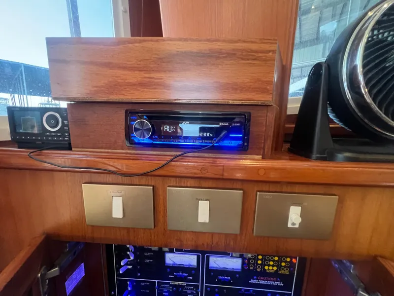 Slide: The Image of 1996 Egg Harbor Convertible boat interior with audio system and control panel. - 44