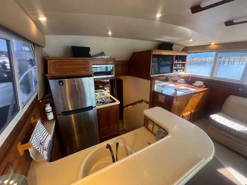 Slide: The Image of Interior of 1996 Egg Harbor Convertible yacht with kitchen and seating area. - 45