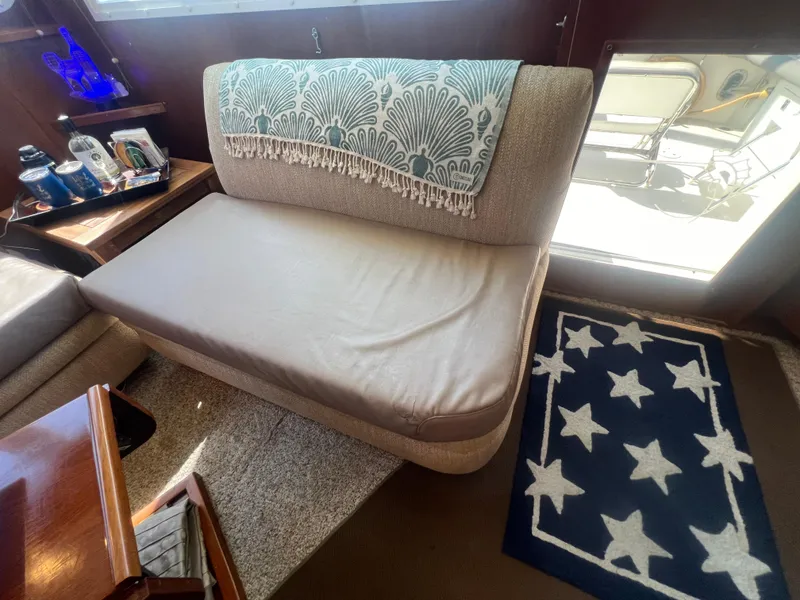 Slide: The Image of Interior of 1996 Egg Harbor Convertible yacht with cozy seating and star-patterned rug. - 48