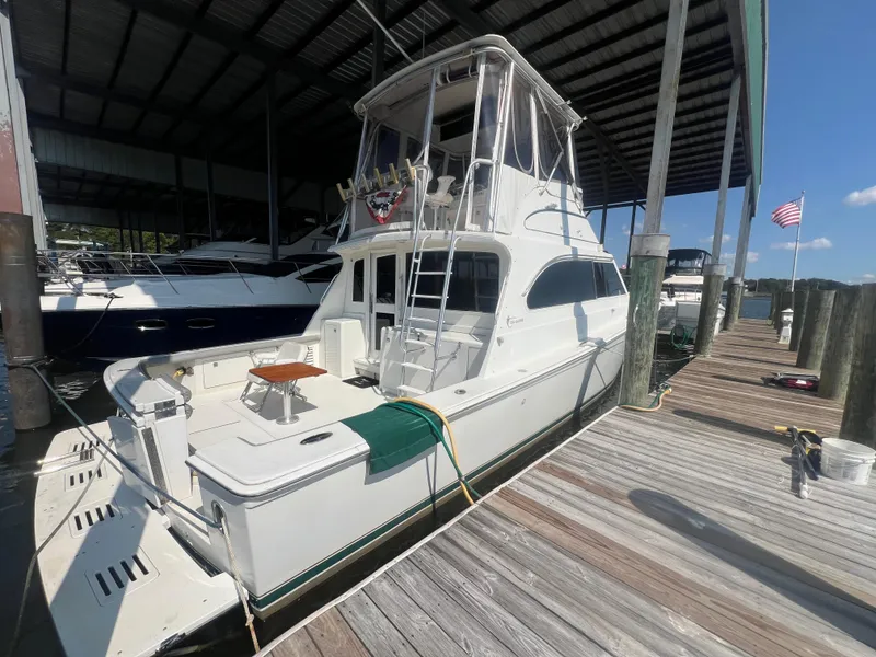 Slide: The Image of 1996 Egg Harbor Convertible yacht docked under a covered marina. - 7