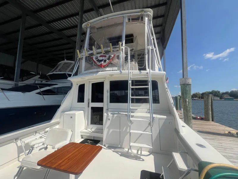 Slide: The Image of 1996 Egg Harbor Convertible yacht docked under a covered marina. - 9