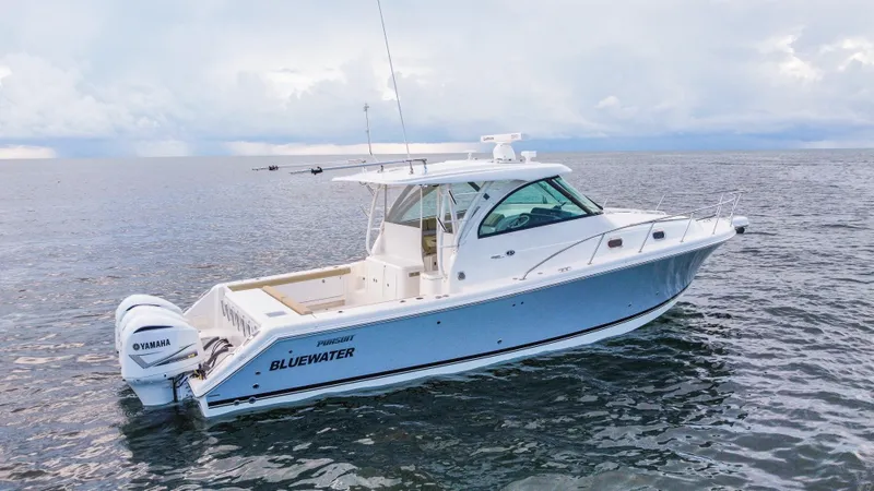 Slide: The Image of 2020 Pursuit OS 385 Offshore boat on open water, side view. - 0