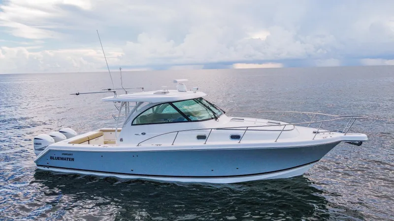 Slide: The Image of 2020 Pursuit OS 385 Offshore boat on calm ocean waters. - 1