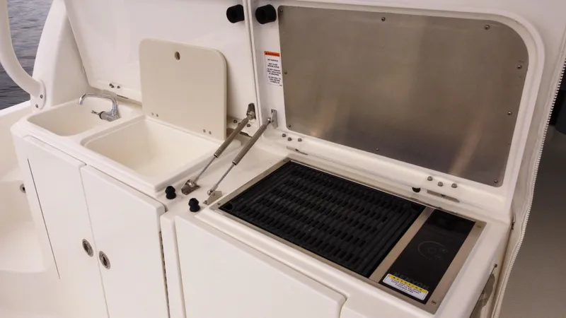 Slide: The Image of 2020 Pursuit OS 385 Offshore boat kitchen with sink and grill. - 10