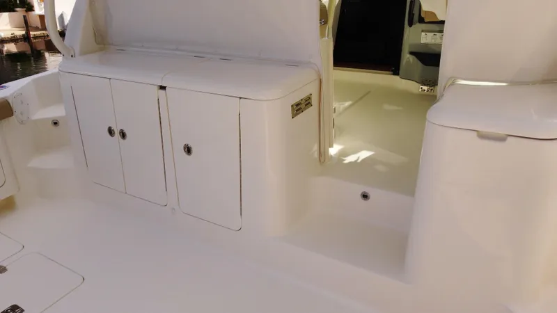 Slide: The Image of 2020 Pursuit OS 385 Offshore boat interior with storage compartments. - 12