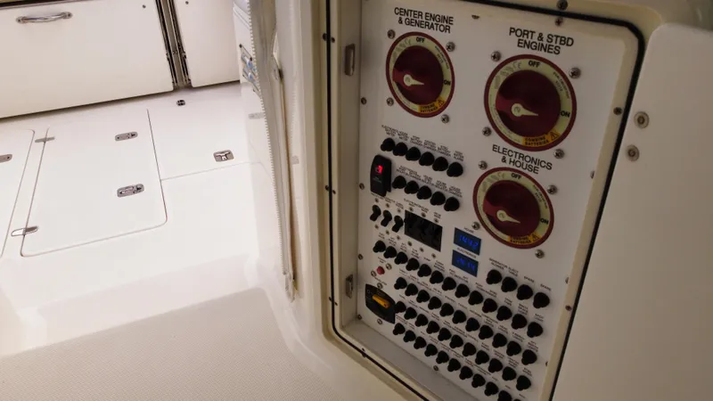 Slide: The Image of Control panel on 2020 Pursuit OS 385 Offshore boat, featuring engine and electronics switches. - 19