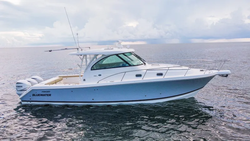 Slide: The Image of 2020 Pursuit OS 385 Offshore boat on open water under cloudy sky. - 2
