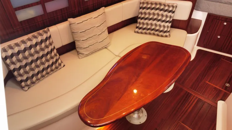 Slide: The Image of Luxurious interior of 2020 Pursuit OS 385 Offshore with elegant wood table and plush seating. - 23