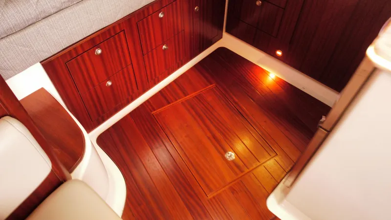 Slide: The Image of Luxurious wood interior of 2020 Pursuit OS 385 Offshore boat cabin. - 24